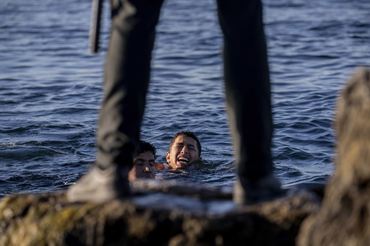 Image: The Spanish civil guard wait for migrants to arrive at the Spanish enclave of Ceuta, near the border of Morocco and Spain