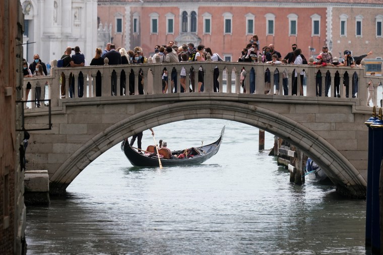 Image: Tourists enjoy the attractions in Venice, Italy