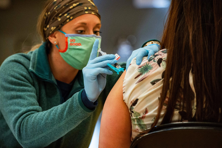 A medical worker administers a Johnson and Johnson Covid-19 vaccination at a FEMA-run mobile vaccination clinic at Biddeford High School in Biddeford, Maine, on April 26, 2021.