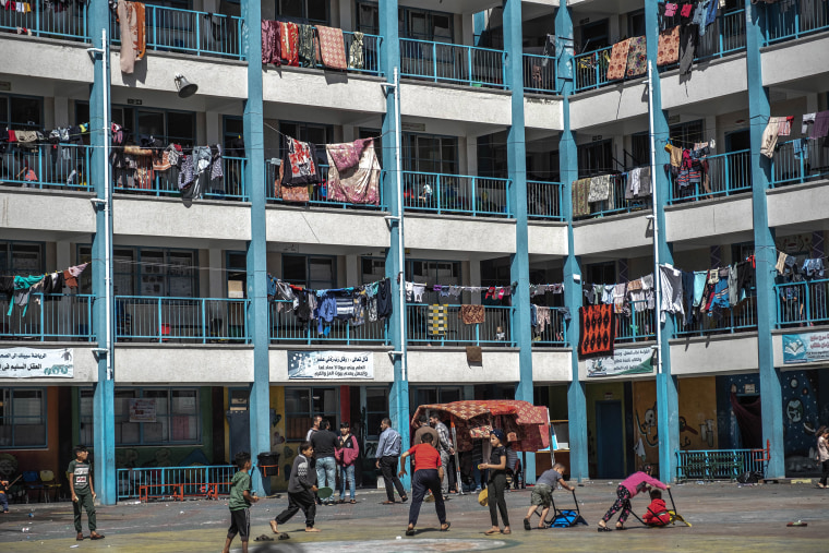 Image: Palestinian children play in a UNRWA school, where some families are now living, following Israeli raids on the northern city of Beit Hanoun in northern Gaza