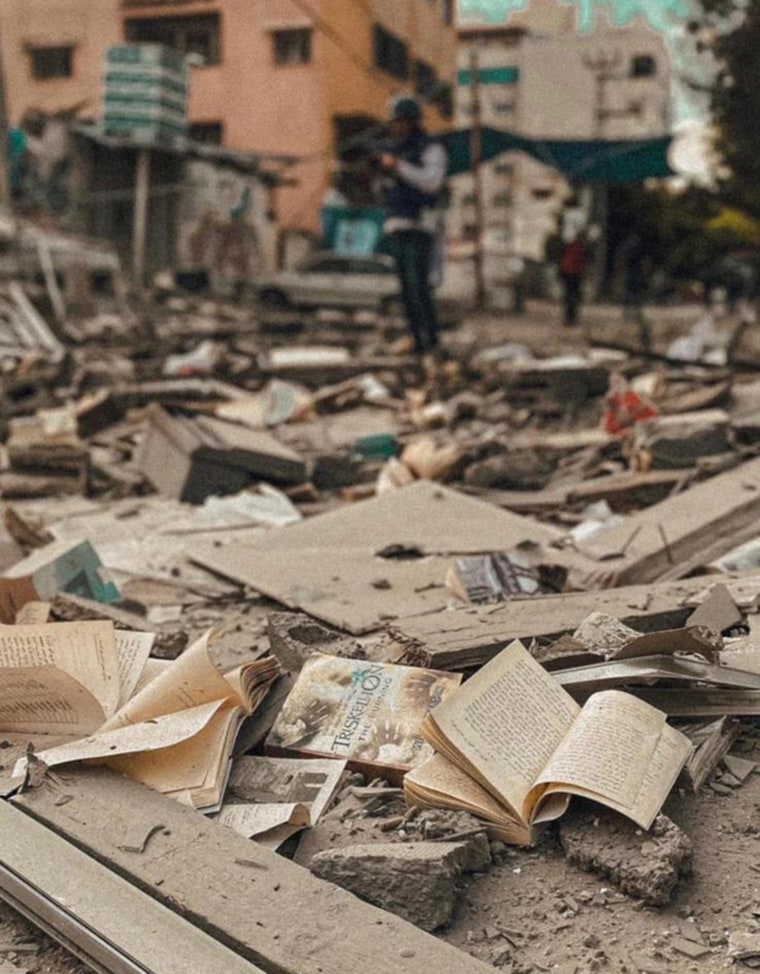 Image: Books from Samir Mansour's bookstore lie in the rubble of the building after it was destroyed on Tuesday morning.