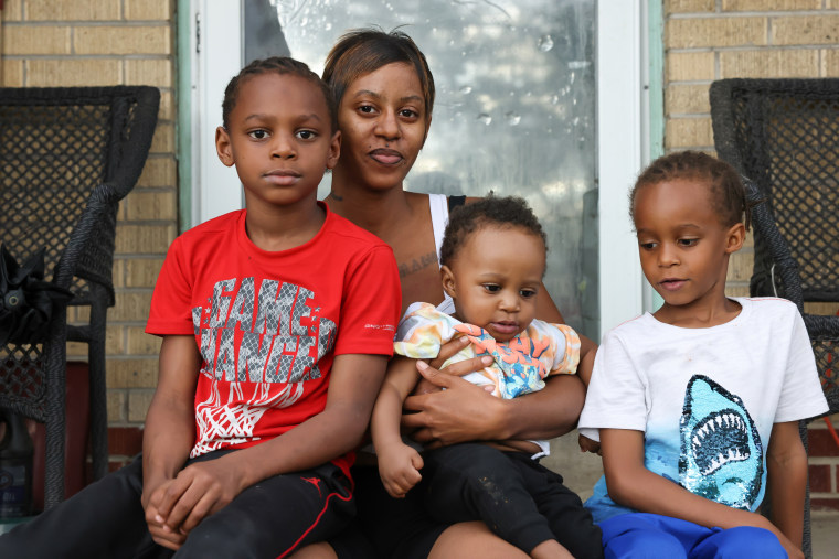 Vanessa Peoples with her sons Tamaj, 7, Mahjae, 6, and Zamari, 11 months, outside her home in Aurora, Colo.