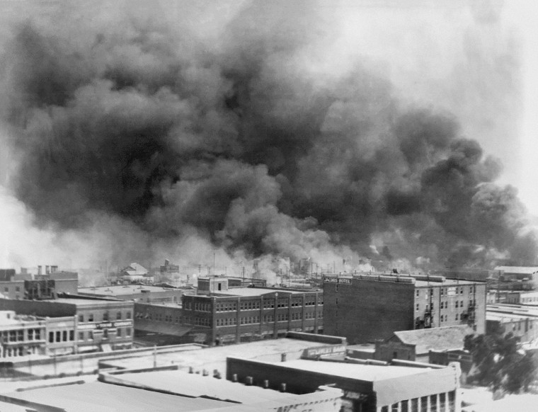 Billowing smoke rises from buildings that were destroyed during the 1921 race riots in Tulsa, Oklahoma. The event became known as the Tulsa Race Massacre. 