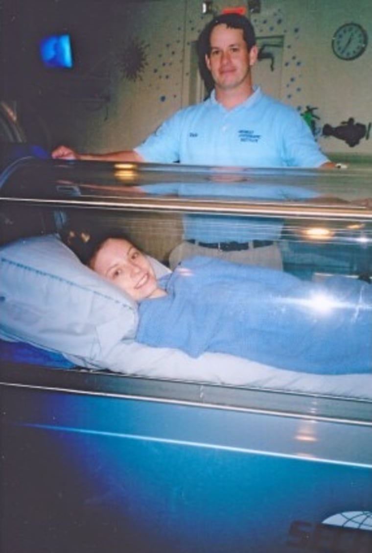 Sarah Kate Frey smiles from a hyperbaric oxygen chamber.