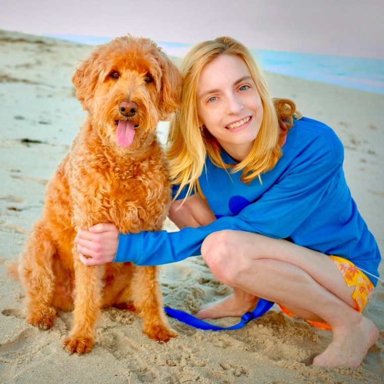 Sarah Kate Frey with her service dog, Alice Eloise, at the beach