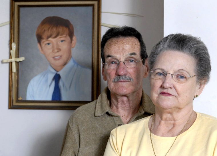Carl and Bunny Croteau stand in front of a portrait of their murdered son, Danny, in their Springfield, Mass. home on Feb. 26, 2008.
