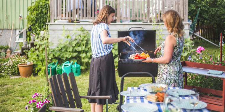 Mother and daughter preparing food on barbecue in backyard party. See the best Memorial Day sales on grills. Shop grills on sale including Weber and Cuisinart grills from Home Depot, Lowes, Macy's and more.