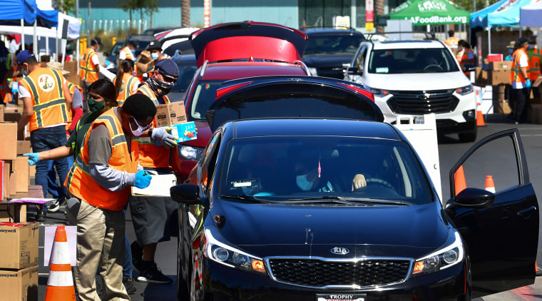 Image: Los Angeles Regional Food Bank workers distribute food in Willowbrook, Calif.
