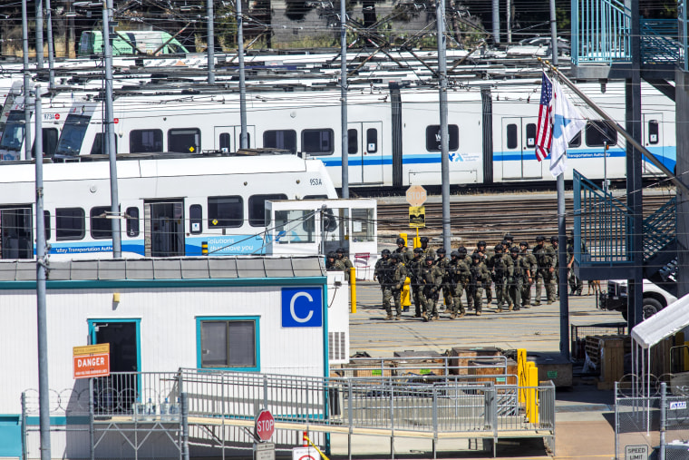 Tactical law enforcement officers move through the Valley Transportation Authority (VTA) light-rail yard where a mass shooting occurred on May 26, 2021 in San Jose, Calif.