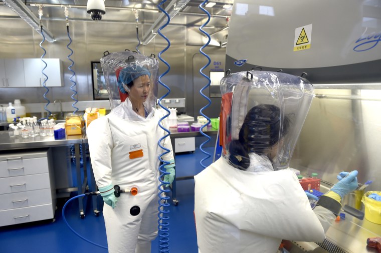 Image: Virologist Shi Zheng-li, left, works with her colleague in the P4 lab of Wuhan Institute of Virology in Wuhan in central China's Hubei province.
