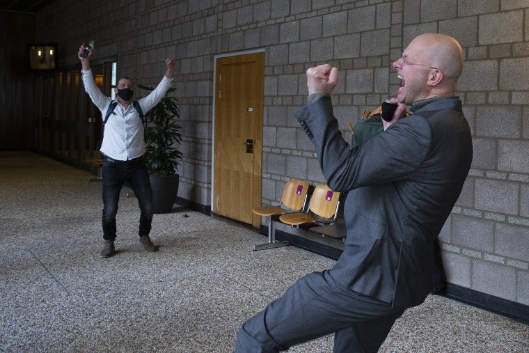Image: Milieudefensie director Donald Pols, right, celebrates the outcome of the verdict in the court case of Milieudefensie, the Dutch arm of the Friends of the Earth environmental organization, against Shell in The Hague