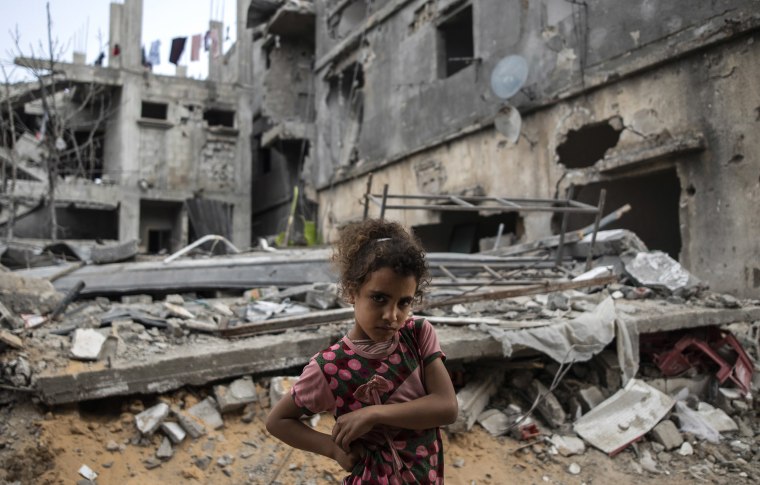 Image: Rahaf Nuseir, 10, looks on as she stands in front of her family's destroyed homes in Beit Hanoun, northern Gaza Strip, on Friday.
