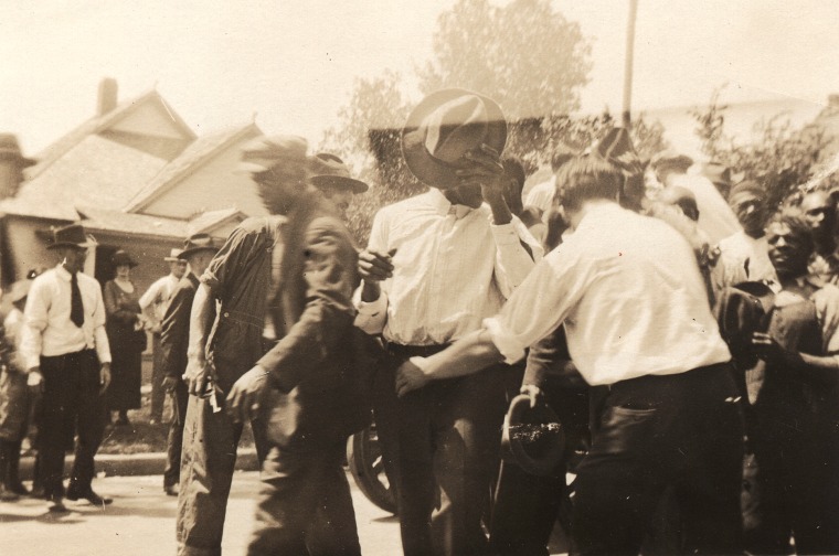 African-American men being detained and led down a residential street on June 1, 1921 in Tulsa, Okla.