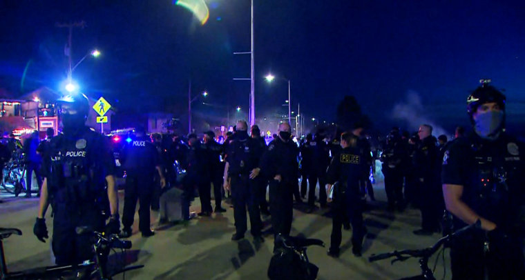 IMAGE: Police clear people from Alki Beach in Seattle on Saturday