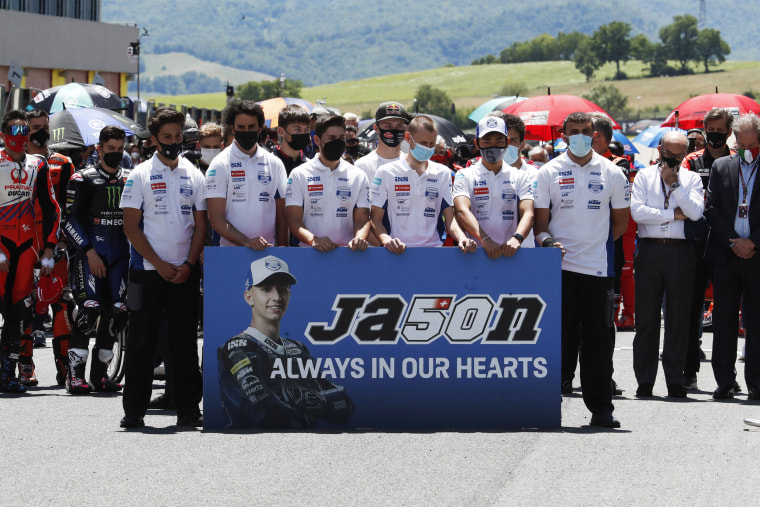 Teammates of 19 years-old Swiss pilot Jason Dupasquier pay a minute of silence in his memory prior to the start of the Motogp Grand Prix of Italy at the Mugello circuit in Scarperia on May 30, 2021.