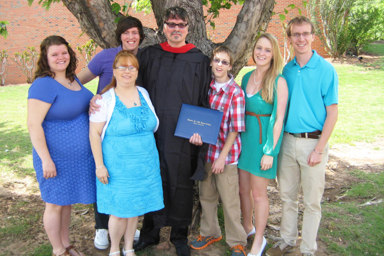 David Evans, center, with his family during his graduation ceremony for his Master's in Ministry.