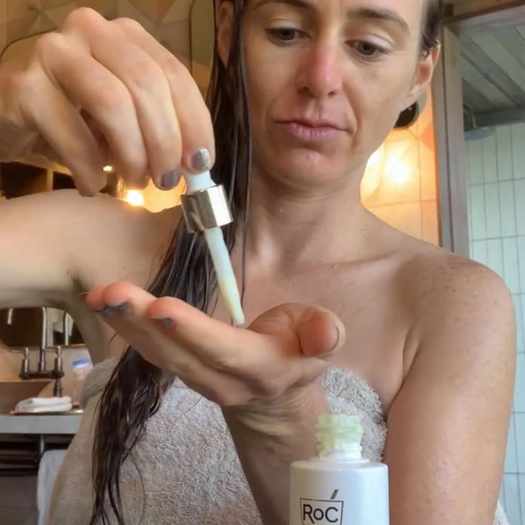 Katie Jackson putting a drop of RoC Retinol Serum on her hand.