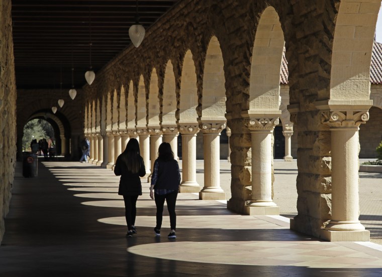 Image: Students walk on the Stanford University campus in Santa Clara, California, on March 14, 2019.