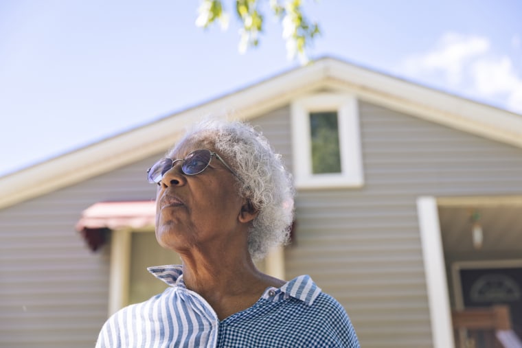 Priscilla Giles stands in front of her childhood home in Evanston, Ill.