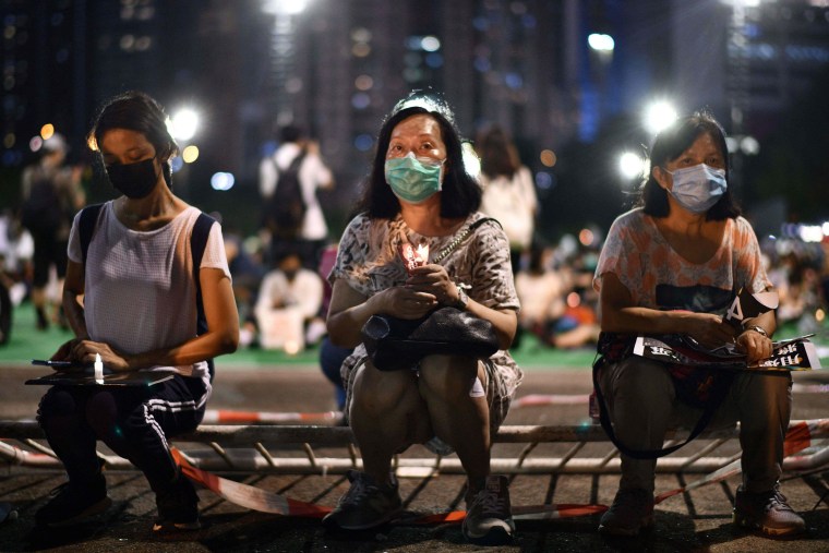 Image: Activists holding a candlelit vigil to remember the Tiananmen Square crackdown in Hong Kong's Victoria Park on June 4, 2020.