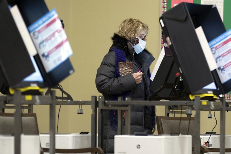 Image: A woman votes after polls opened in Georgia's Senate runoff elections on Jan. 5, 2021, in Acworth, Ga.