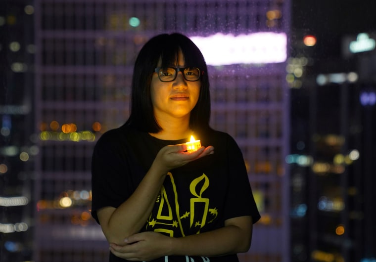 Image: Chow Hang Tung, vice chairwoman of Hong Kong Alliance in Support of Patriotic Democratic Movements of China, poses with a candle