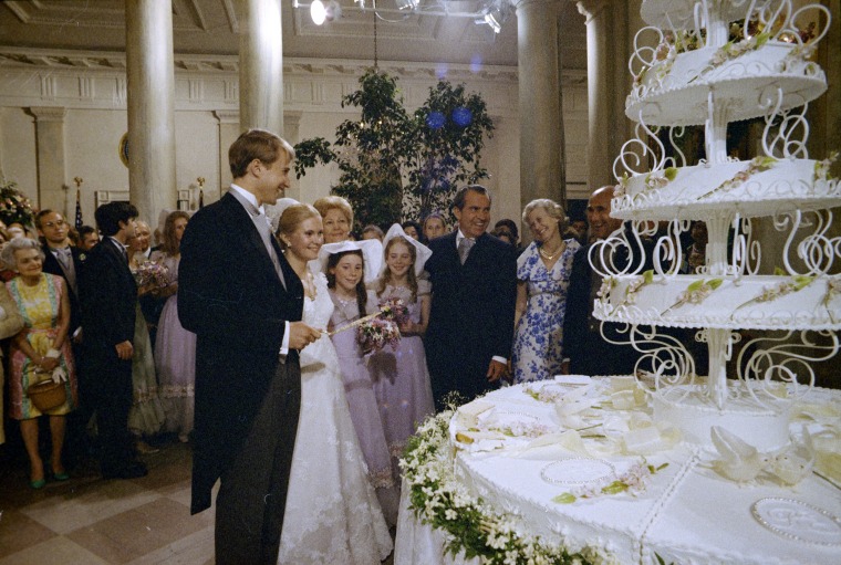 Edward Cox and Tricia Nixon cut their wedding cake.