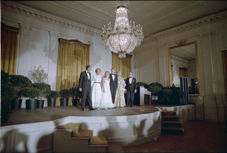 President Nixon, Pat Nixon, Tricia Nixon, Edward Cox, Howard Cox, Anne Cox on stage in the East Room announcing the engagement on March 16, 1971.