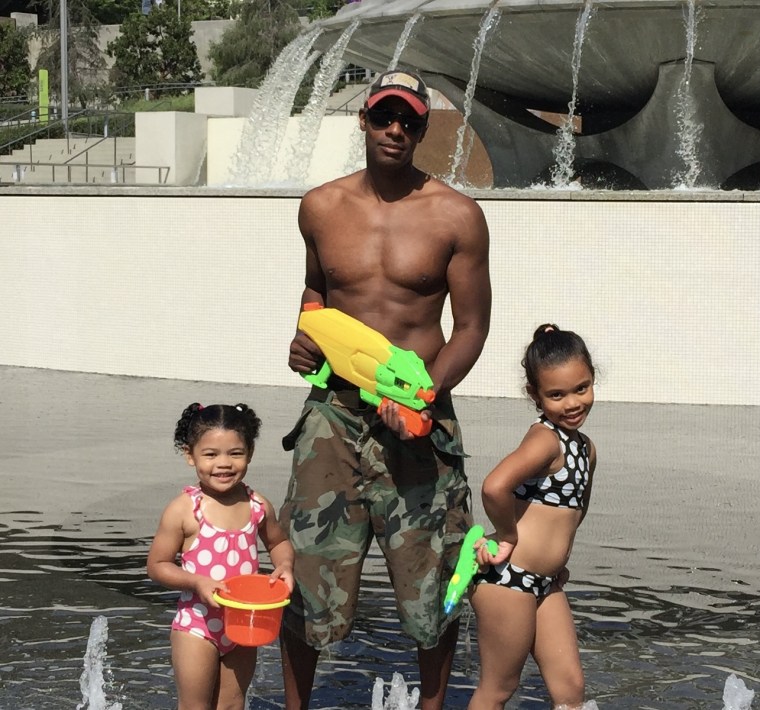 Doyin Richards with his two young daughters at a water park.