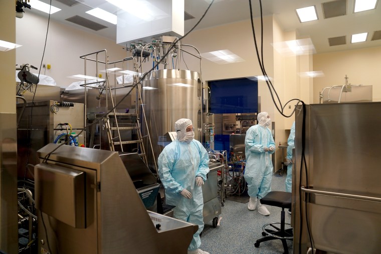 Employees work in a lab at Emergent Biosolutions, which is manufacturing vaccines for AstraZeneca and Johnson Johnson, on Feb, 8, 2021 in Baltimore, Md.
