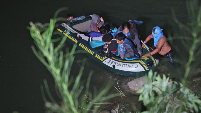 IMAGE: Migrants cross the Rio Grande