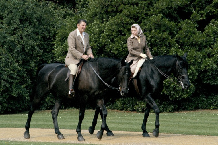 Queen Elizabeth II riding in the grounds of Windsor Castle with President Ronald Reagan, during his state visit to the UK, June 8, 1982. She is riding her horse 'Burmese' and he is mounted on 'Centennial', both gifts to the Queen from the Canadian Mounted Police.