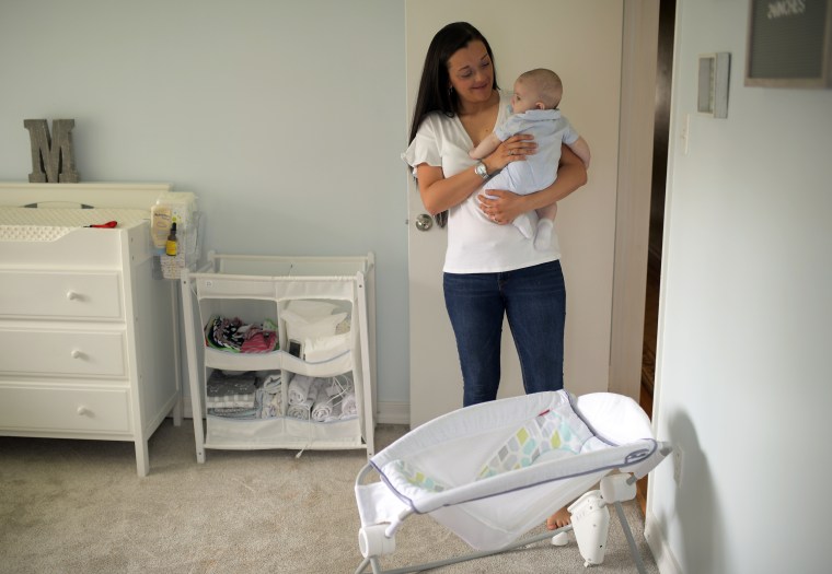 Miana Marie holds her 4-month-old son Mason on April 16, 2019. She had used the Fisher-Price Rock 'n Play sleeper, bottom, for Mason until the recall.