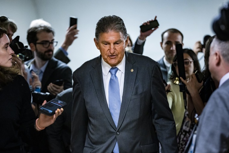 Image: Reporters surround Sen. Joe Manchin, D-W.V. as he heads to a vote in the Senate on June 8, 2021.