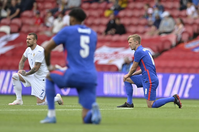 Image: England's and Romania's players take a knee before the international friendly soccer match between England and Romania in Middlesbrough, England