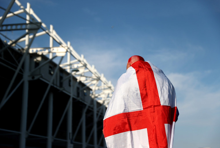 Image: An England fan wears a flag outside the stadium during the international friendly match between England and Austria at Riverside Stadium