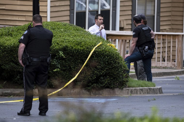 Image: Law enforcement officers wait outside of a Sandy Springs, Ga., apartment where Gary Creek died Tuesday, June 8, 2021, following a SWAT standoff.