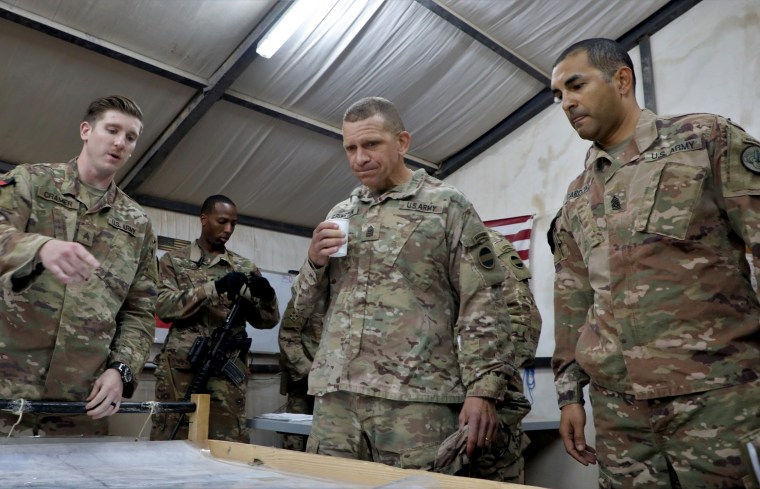 Command Sgt. Maj. Michael Grinston, center, discusses ongoing operations in Al-Qa'im, Iraq, on Nov. 18, 2018.