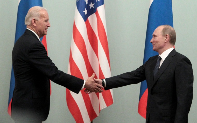 Image: Russian Prime minister Putin shakes hands with U.S. Vice President Biden during their meeting in Moscow
