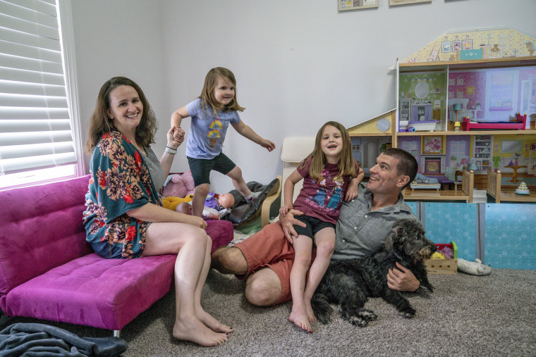 Annie Whitlock and her husband Mike at home with their daughters McKenzie and Maggie.