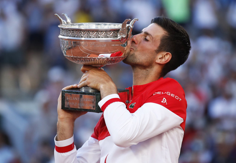 Serbia's Novak Djokovic kisses his trophy after winning the French Open against Greece's Stefanos Tsitsipas in Paris on June 13, 2021.