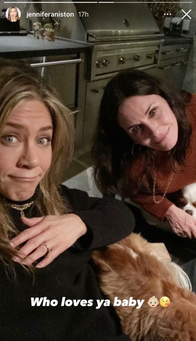 Aniston shared a photo of her and Cox hanging out, joined by what looks like Cox's two Cavalier King Charles spaniels, Bear and Lily. 