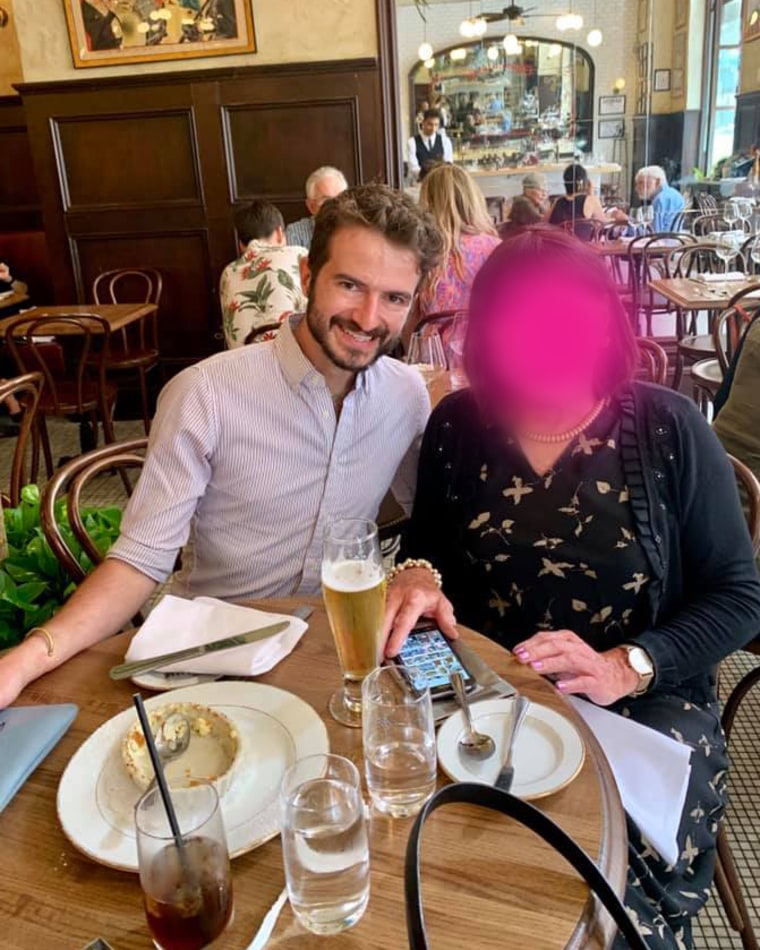 Father and son eating in a restaurant, father's face is blurred