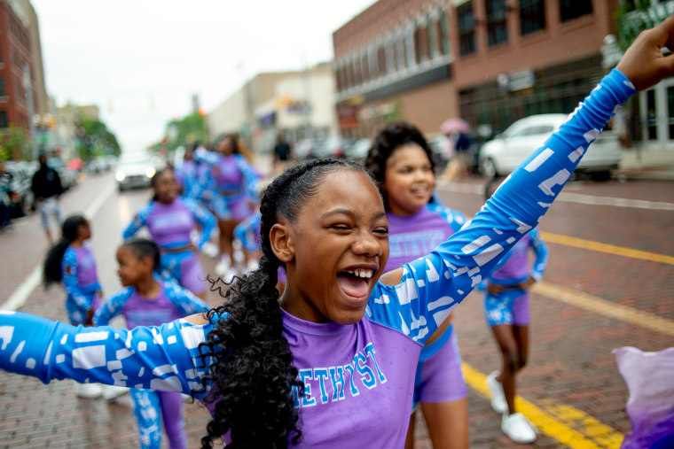 Lexi Watson, 10, of Flint, smiles as she shouts out with joy in downtown Flint, Michigan.