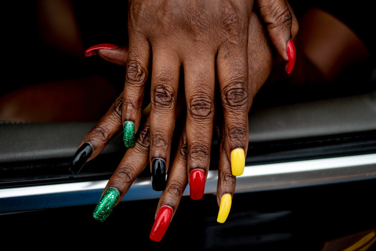 Flint resident Tracy Palmer shows off her Juneteenth-inspired nails