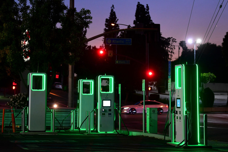 Image: An Electric Vehicle charging station lights up green in the parking lot of a Ralph's supermarket in Monterey Park, Calif., on May 18, 2021.