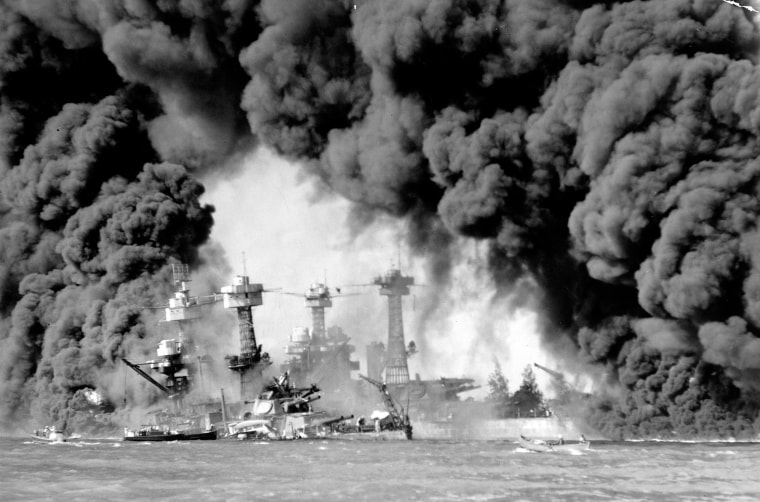 Image: Smoke pours from wrecked American battleships USS West Virginia &amp; USS Tennessee during the surprise Japanese attack on Pearl Harbor.