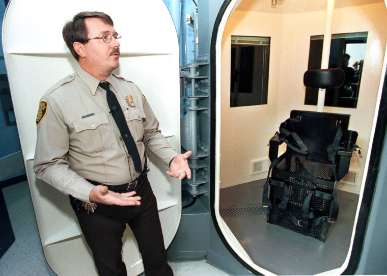 Image: Correctional Officer Jim Robideau shows the gas chamber at the Florence Prison Complex in Florence, Ariz.
