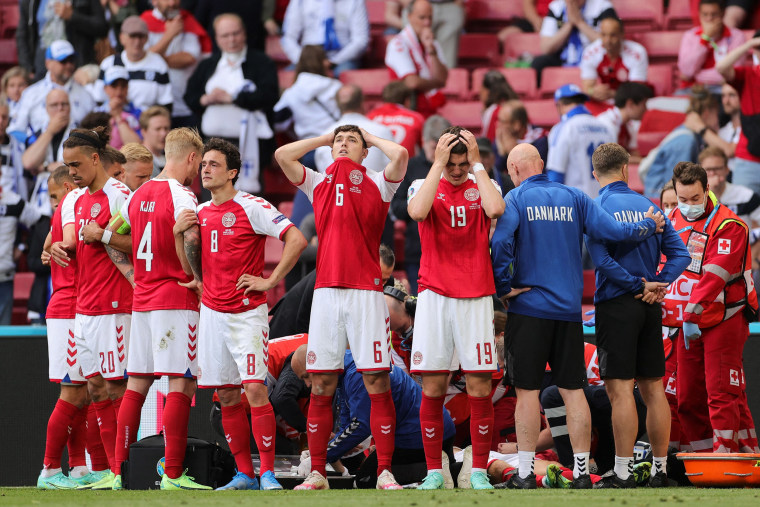 Image: Denmark's players react as paramedics attend to Denmark's midfielder Christian Eriksen after he collapsed on the pitch during the UEFA EURO 2020 Group B football match between Denmark and Finland at the Parken Stadium in Copenhagen