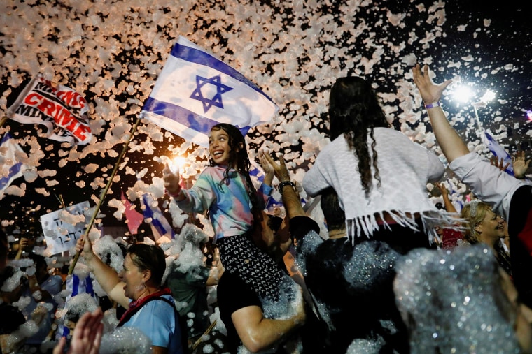 Image: People celebrate after Israel's parliament voted in a new coalition government, ending Benjamin Netanyahu's 12-year hold on power, at Rabin Square in Tel Aviv, Israel